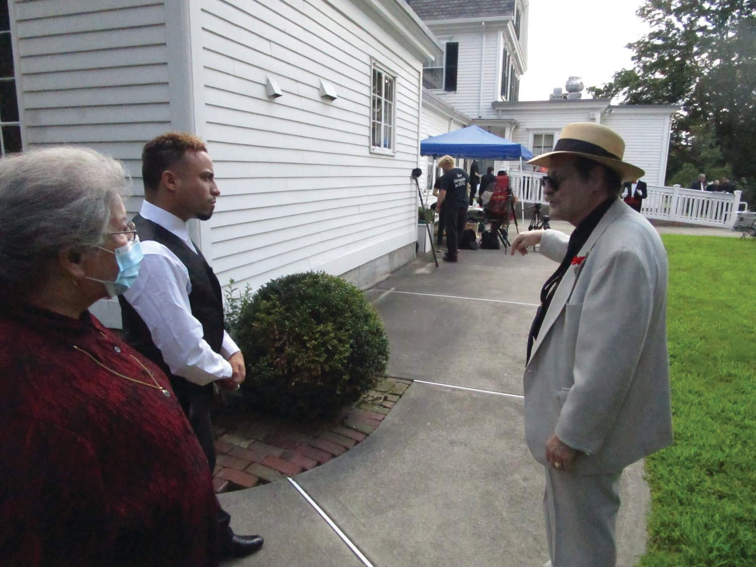HOME TEAM: Gregg Mierka, right, and Mary Mierka, left, resident caretakers of Sprague Mansion, speak with cast member Jesse Vega ahead of Saturday’s shoot for “Poor Paul.” Gregg, who has appeared in several films and shows over the years, played a small role in the production.